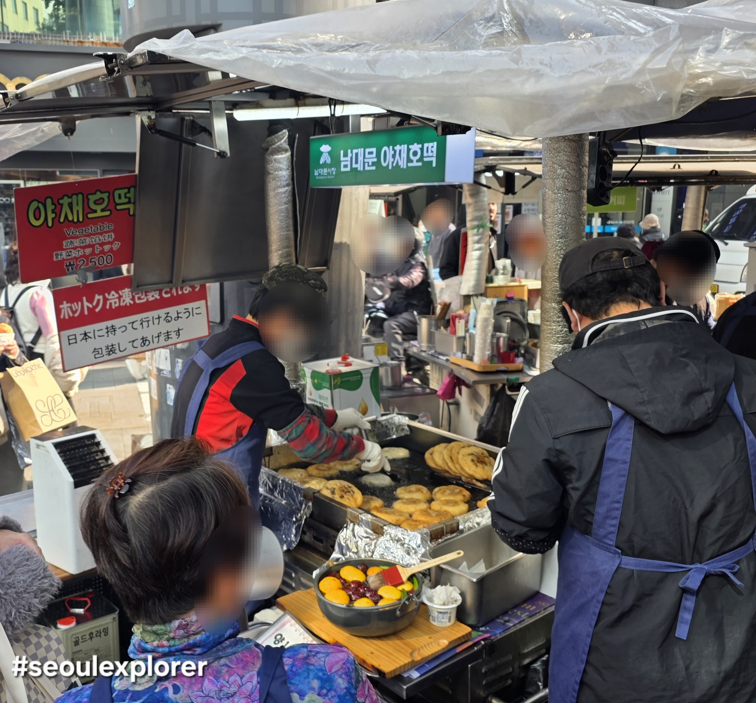 A vendor making Korean vegetable hotteok at Namdaemun Market
