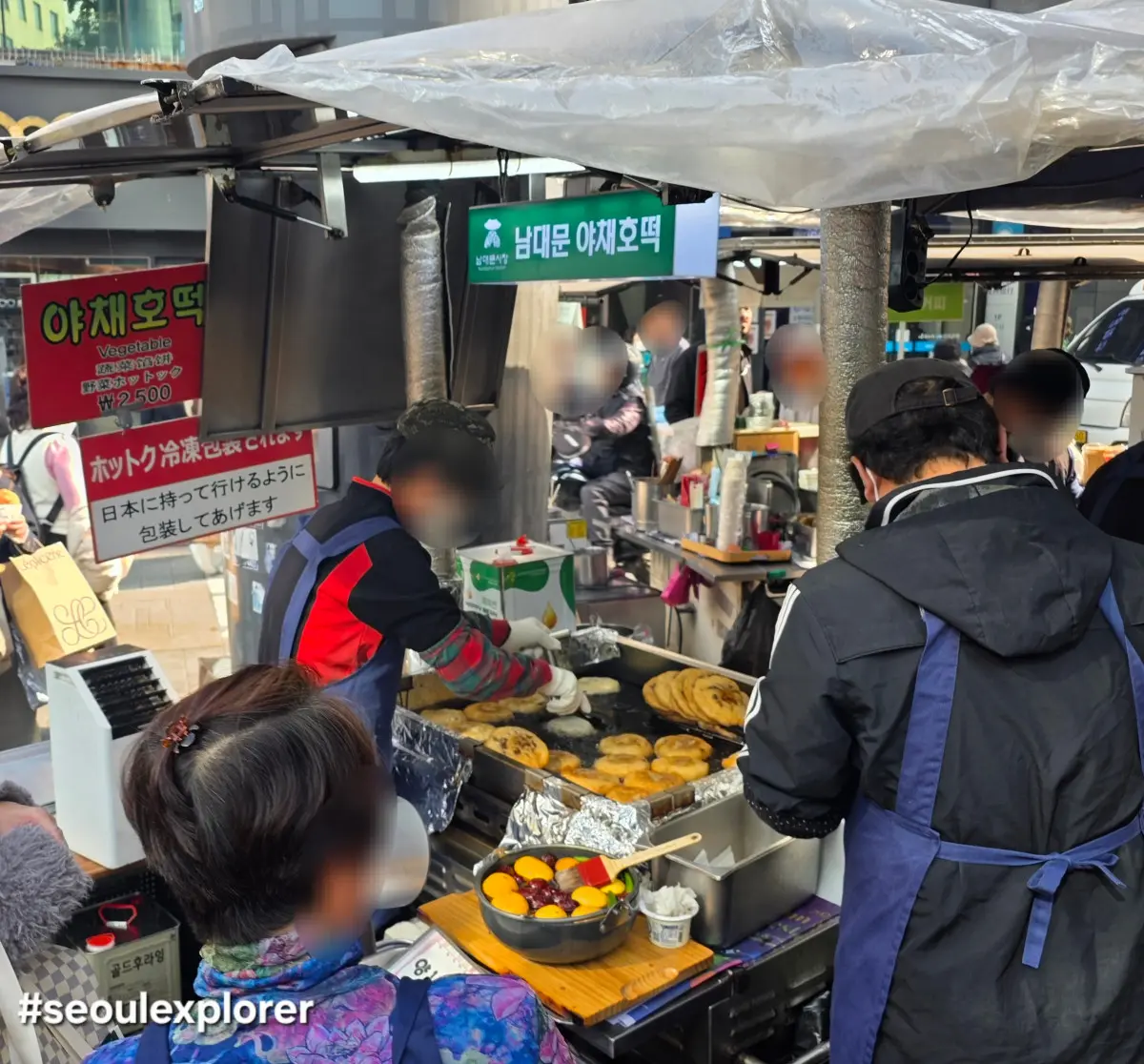 A vendor making Korean vegetable hotteok at Namdaemun Market