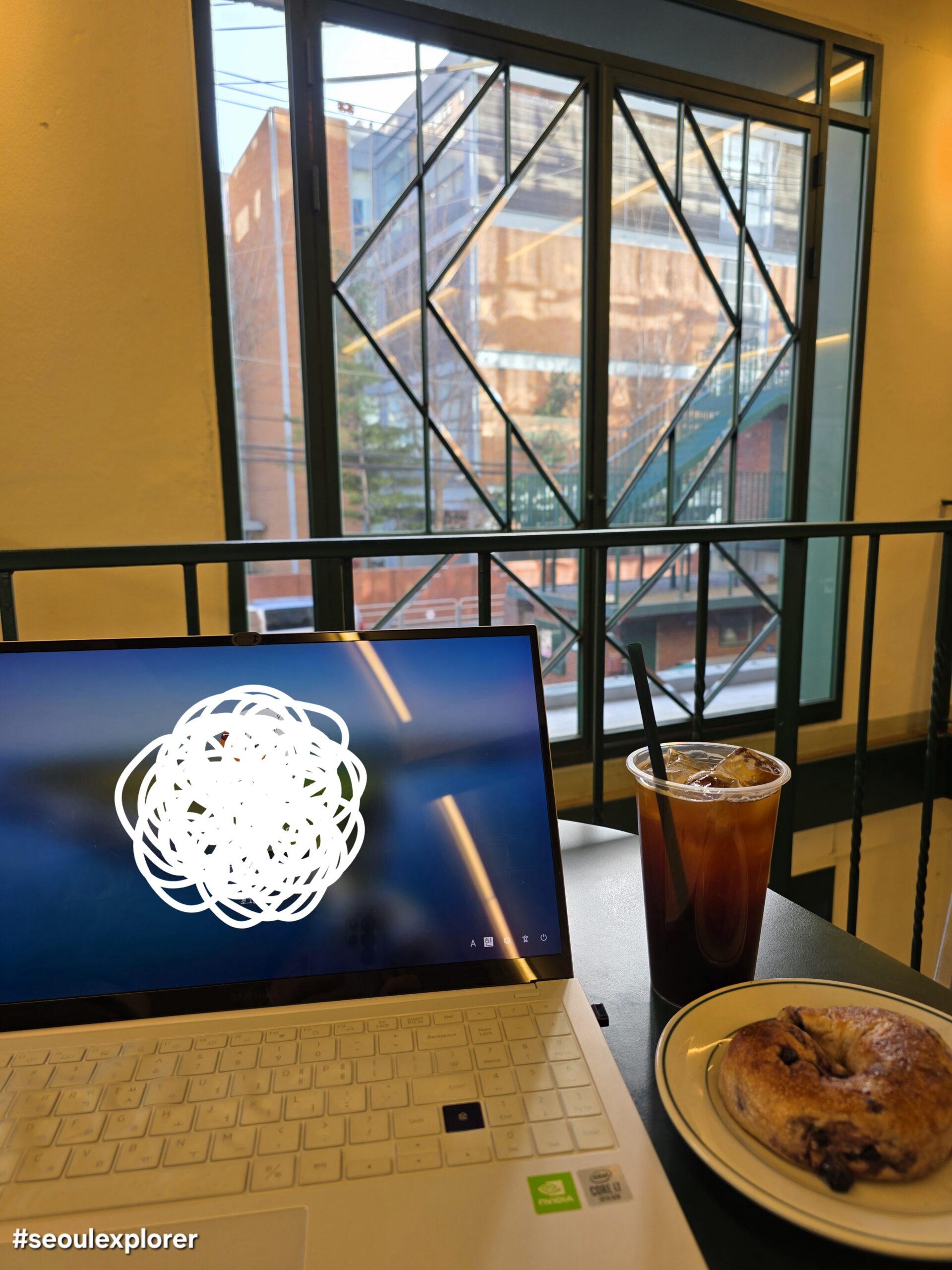 Laptop and coffee at a workation cafe in Seoul