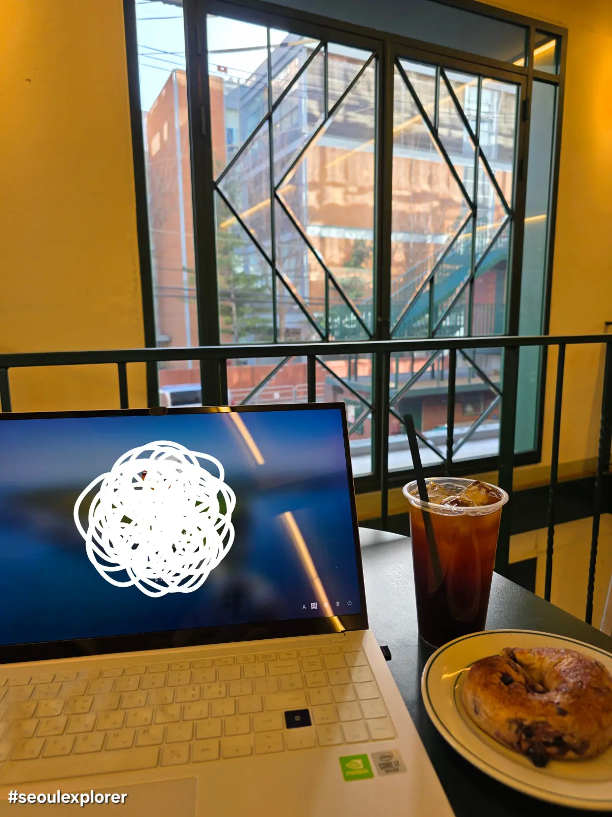 Laptop and coffee at a workation cafe in Seoul