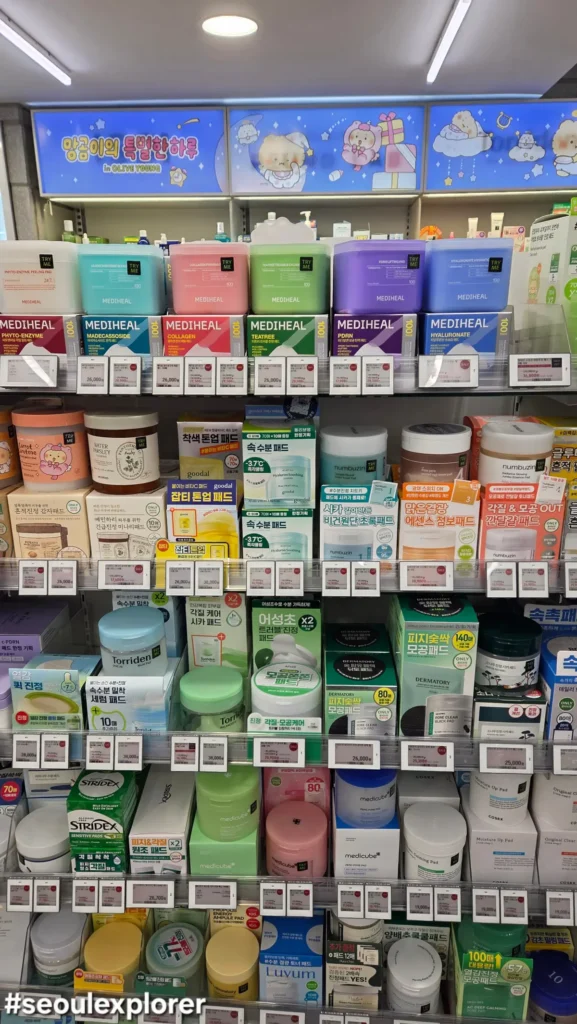 Popular Korean toner pads on an Olive Young shopping list shelf