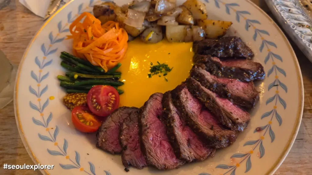 Plating of grilled steak with vegetables at Blue Sho Pasta