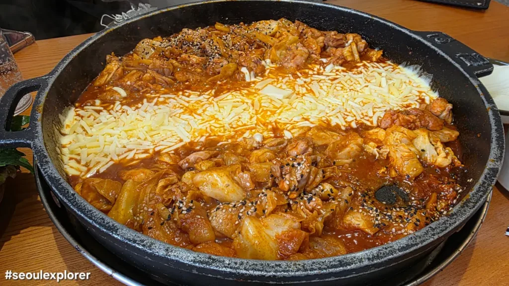A sizzling pan of cheese and spicy chicken