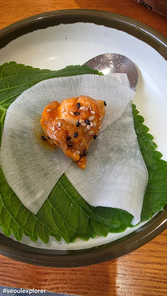 A chicken wrap on a perilla leaf