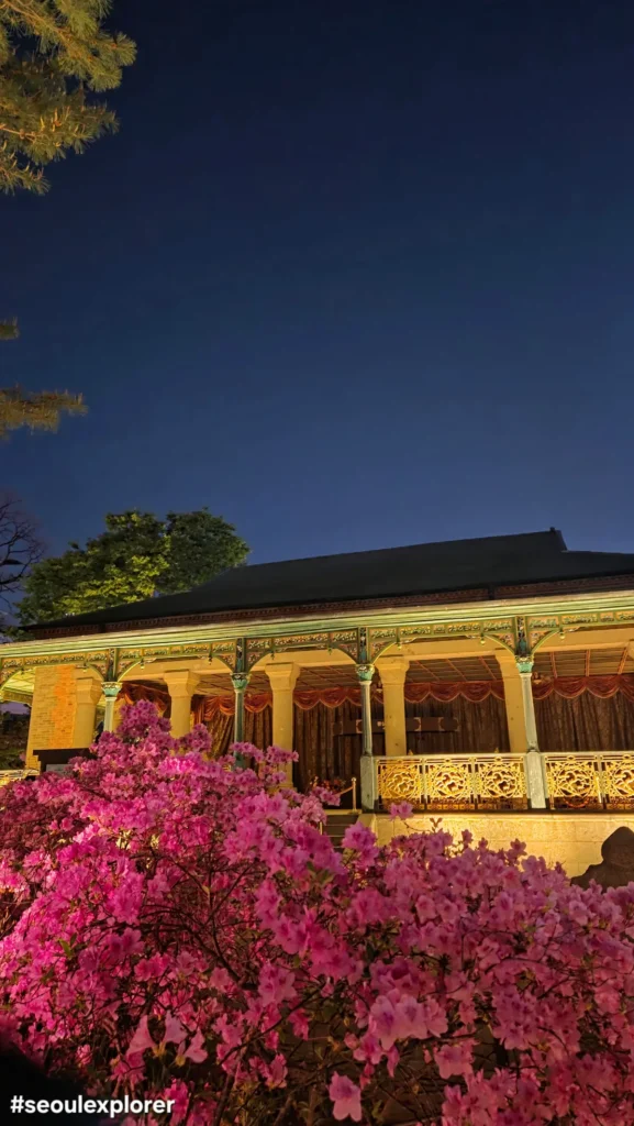 Jeonggwanheon Pavilion at night with flowers