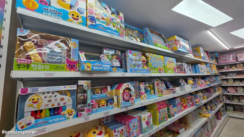 Rows of Pinkfong and Baby Shark toys on display shelves at a store