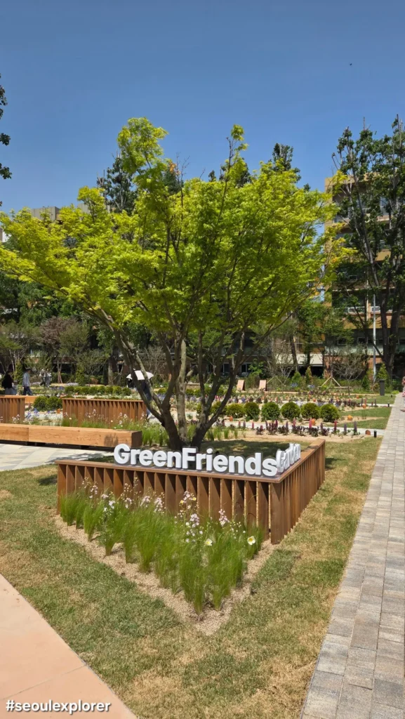 GreenFriends Garden sign and green tree