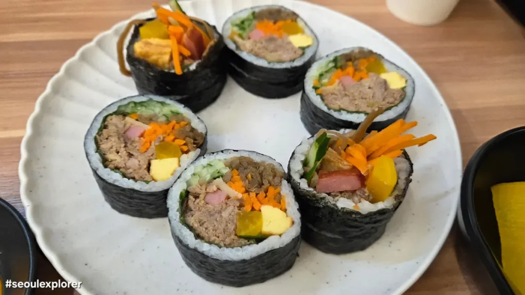 Tuna gimbap slices on a plate